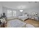 Bright bedroom with ample natural light, featuring a decorative chandelier and stylish furnishings at 1205 Brooksland Pl, Waxhaw, NC 28173