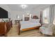 Well-lit primary bedroom with hardwood floors, and traditional furnishings with canopy bed and decor at 1205 Brooksland Pl, Waxhaw, NC 28173