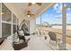 Inviting screened patio featuring tile floors, ceiling fans, and comfortable seating with backyard view at 1205 Brooksland Pl, Waxhaw, NC 28173