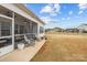 Cozy screened porch with ceiling fans and comfortable seating, offering a relaxing outdoor space with backyard access at 1205 Brooksland Pl, Waxhaw, NC 28173