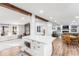 Open-concept living and kitchen area with exposed beams, modern appliances, and a view of the spacious living area at 126 Goat Trl, China Grove, NC 28023