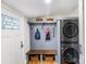 Functional mudroom featuring a bench, storage baskets, hooks, and a convenient washer and dryer at 126 Goat Trl, China Grove, NC 28023