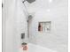 Modern shower featuring sleek marble tiles, a rainfall showerhead, and convenient storage niche at 126 Goat Trl, China Grove, NC 28023