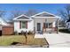 Charming home with a covered porch, complemented by brown shutters and a well-maintained front yard at 1305 Price Ave, Kannapolis, NC 28081