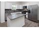 Bright kitchen with an island, granite counters, stainless steel appliances, and mosaic backsplash at 1305 Price Ave, Kannapolis, NC 28081
