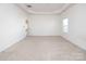 Bright, carpeted main bedroom with a tray ceiling and a view to the entry way at 1305 Price Ave, Kannapolis, NC 28081