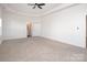 Spacious main bedroom with tray ceiling, ceiling fan, and large walk-in closet at 1305 Price Ave, Kannapolis, NC 28081