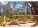 New wooden deck overlooks lush greenery and natural landscape for serene outdoor enjoyment at 132 Shady Grove Rd, Kings Mountain, NC 28086