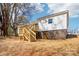 Exterior back view of a white house with wooden deck, stairs, and a basement entrance at 132 Shady Grove Rd, Kings Mountain, NC 28086
