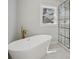 Modern bathroom features a freestanding tub, glass shower with black trim, and stylish gold fixtures at 132 Shady Grove Rd, Kings Mountain, NC 28086