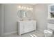 Bright bathroom featuring double vanity with stylish lighting, round mirrors and decorative floor tiles at 132 Shady Grove Rd, Kings Mountain, NC 28086