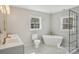Modern bathroom features a freestanding tub, glass shower, dual sink vanity and patterned tile floor at 132 Shady Grove Rd, Kings Mountain, NC 28086