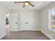 Bedroom with wood-look flooring, a window, closet, and a white door leading to other rooms at 132 Shady Grove Rd, Kings Mountain, NC 28086