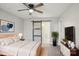 This stylish bedroom includes a plant, bedroom set, sliding barn door to a bathroom, and wood-look floors at 132 Shady Grove Rd, Kings Mountain, NC 28086
