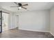 This bedroom features gray walls, wood-look floors, base molding and a sliding barn door to a bathroom at 132 Shady Grove Rd, Kings Mountain, NC 28086