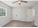 This bedroom features gray walls, wood-look floors, base molding, a ceiling fan and a closet at 132 Shady Grove Rd, Kings Mountain, NC 28086