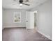 Bright bedroom features light gray walls, a ceiling fan, wood-look floors, and a large window at 132 Shady Grove Rd, Kings Mountain, NC 28086