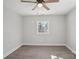 This bedroom features gray walls, wood-look floors, base molding, a ceiling fan and a window at 132 Shady Grove Rd, Kings Mountain, NC 28086