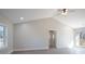 Neutral bedroom with a ceiling fan, vaulted ceiling, and a window with a view of the outdoors at 132 Shady Grove Rd, Kings Mountain, NC 28086