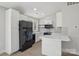 Well-lit kitchen featuring white cabinets, modern appliances, and quartz countertops at 132 Shady Grove Rd, Kings Mountain, NC 28086