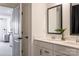 Modern bathroom with double sink vanity, black hardware, and an open doorway to adjacent room at 13943 Penbury Ln # 376, Charlotte, NC 28278