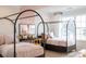 Charming bedroom featuring twin beds with modern frames, soft pink bedding, and bright, sunny window at 13943 Penbury Ln # 376, Charlotte, NC 28278