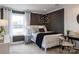 Serene bedroom with a plush bed, butterfly wall decor, and a view from a bright, sunny window at 13943 Penbury Ln # 376, Charlotte, NC 28278