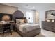 Cozy bedroom with a baseball themed art, gray bedding, and contemporary furnishings on soft carpet at 13943 Penbury Ln # 376, Charlotte, NC 28278