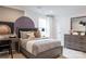 Cozy bedroom with a baseball themed art, gray bedding, and contemporary furnishings on soft carpet at 13943 Penbury Ln # 376, Charlotte, NC 28278