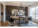 Elegant dining room featuring modern chandelier, stylish decor, and a large, bright window at 13943 Penbury Ln # 376, Charlotte, NC 28278