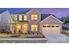 Charming two-story brick home with a manicured lawn and inviting front porch with rocking chairs at 13943 Penbury Ln # 376, Charlotte, NC 28278