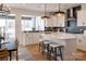 Modern kitchen features white cabinets, stainless steel appliances, subway tile and a breakfast bar at 13943 Penbury Ln # 376, Charlotte, NC 28278