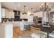 Modern kitchen featuring white cabinets, stainless steel appliances, a breakfast bar and open dining area at 13943 Penbury Ln # 376, Charlotte, NC 28278