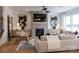 Cozy living room with a brick fireplace, lots of light, and hardwood floors at 13943 Penbury Ln # 376, Charlotte, NC 28278