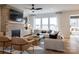 Bright living room with a brick fireplace, modern furnishings, and a large window at 13943 Penbury Ln # 376, Charlotte, NC 28278
