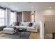 Bright living room featuring a comfortable sectional sofa, decorative pillows, and stylish wall decor at 13943 Penbury Ln # 376, Charlotte, NC 28278