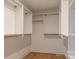 Walk-in closet featuring ample shelving and closet rods for optimal organization and storage space at 13943 Penbury Ln # 376, Charlotte, NC 28278