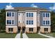 New townhome design with brick accents, a well-manicured lawn, and large windows at 1417 Lithium Ln, Charlotte, NC 28211