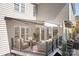 Back deck featuring outdoor seating, a retractable awning, and stairs leading down to the backyard at 15124 Hugh Mcauley Rd, Huntersville, NC 28078