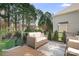 Back deck featuring an outdoor sofa, a decorative rug, black metal railings, and shade trees at 15124 Hugh Mcauley Rd, Huntersville, NC 28078