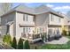 Back exterior featuring a patio, deck, grill, well-maintained lawn, and a home with light-colored siding at 15124 Hugh Mcauley Rd, Huntersville, NC 28078