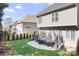 Large backyard with a well-kept lawn, black metal railings, a stone patio, a grill, and stairs to the deck at 15124 Hugh Mcauley Rd, Huntersville, NC 28078