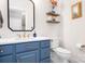 Charming bathroom featuring a blue vanity, a unique mirror, and stylish decorations at 15124 Hugh Mcauley Rd, Huntersville, NC 28078