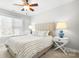 Bright bedroom featuring a striped bed, bedside lamps, and a ceiling fan at 15124 Hugh Mcauley Rd, Huntersville, NC 28078