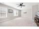 Spacious carpeted bedroom with a ceiling fan, large windows, and ample natural light at 15124 Hugh Mcauley Rd, Huntersville, NC 28078