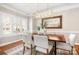 Dining room featuring a wooden table, seating for six, modern lighting, and large window for natural light at 15124 Hugh Mcauley Rd, Huntersville, NC 28078