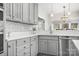 Modern kitchen featuring gray cabinets, quartz countertops, a mosaic backsplash, and stainless steel appliances at 15124 Hugh Mcauley Rd, Huntersville, NC 28078