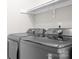 Modern laundry room showcasing a large, front-loading washer and dryer set at 15124 Hugh Mcauley Rd, Huntersville, NC 28078