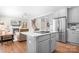 Open-concept living space with a kitchen island, fireplace, and comfortable seating at 15124 Hugh Mcauley Rd, Huntersville, NC 28078