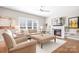 Inviting living room with a fireplace, built-in shelves, comfortable seating, and natural light at 15124 Hugh Mcauley Rd, Huntersville, NC 28078
